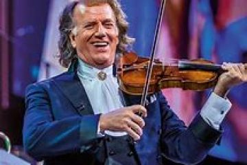 Andre Rieu holding a guitar